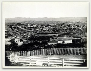 View of the Mission in 1865, described as, "Looking E. from Reservoir Hill, Market & Buchanan Sts., Vicinity Market & Valencia." The "rolling ..." described by Palou are absent, with the only tree visible in the scene located near the fence in the lower left. Courtesy of the San Francisco Historical Photograph Collection, San Francisco Public Library.